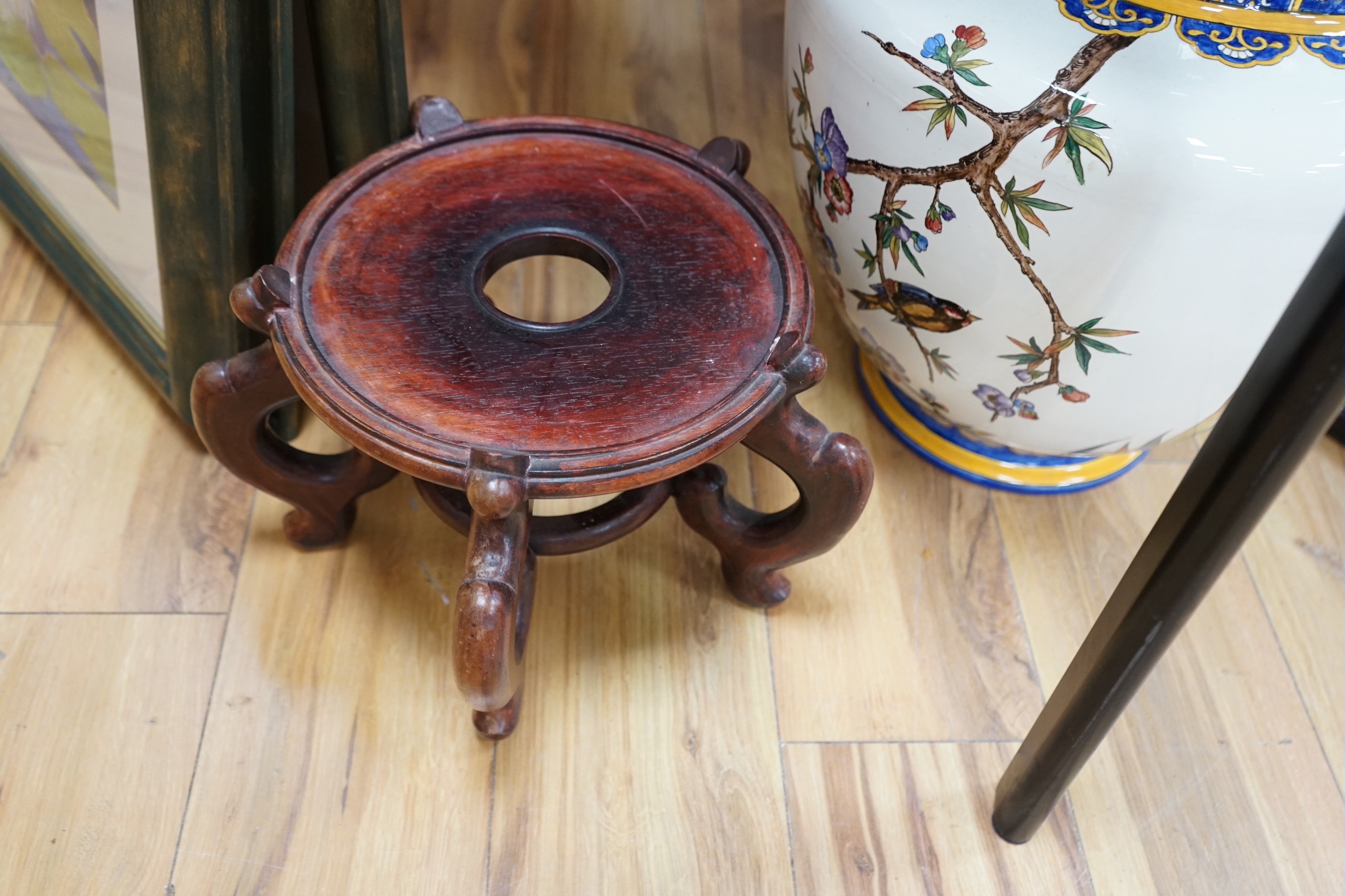 A Gien faience vase, painted with irises, raised on a hardwood stand, 68cm total height